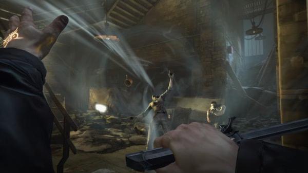 Dishonored screenshot: A player wields a blade and uses powers against two enemies in a dimly lit, rubble-filled room.