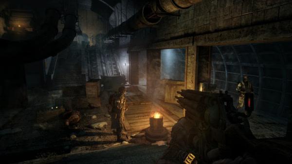 A Metro 2033 Redux screenshot showing a dimly lit underground tunnel with armed characters near a fire barrel.
