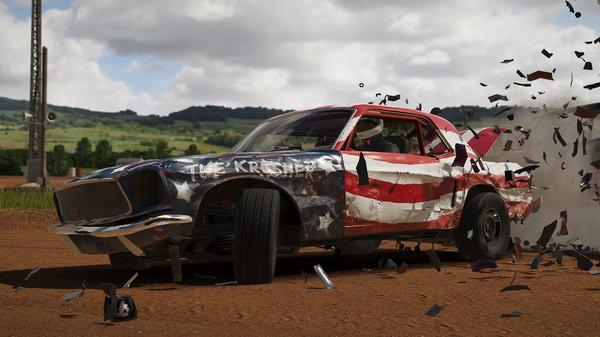 Wreckfest screenshot: A damaged car with a red, white, and blue paint job crashes on a dirt track, scattering debris.