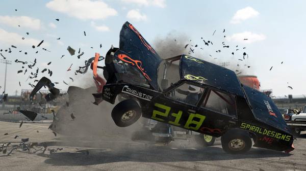 Wreckfest screenshot: Two cars collide mid-air, debris flying as destruction unfolds on a racetrack under a clear sky.