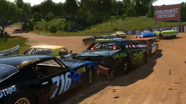 A Wreckfest screenshot showing a chaotic dirt track race with damaged cars colliding near a "Frecwest Motors" sign.
