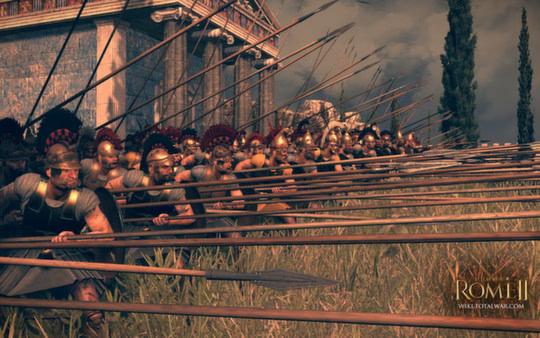 A phalanx of soldiers with long spears stands ready in front of a temple in this Total War: Rome II - Emperor Edition screenshot.