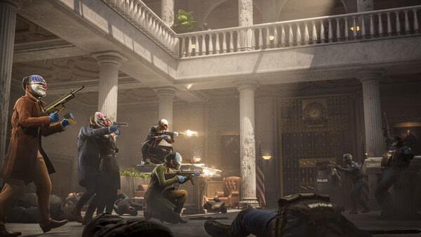 PAYDAY 3 screenshot showing masked players in a bank lobby engaged in a firefight with police, surrounded by fallen bodies and gunfire.