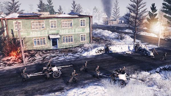 Screenshot from Call to Arms - Gates of Hell: Ostfront showing soldiers maneuvering artillery in a snowy village setting.