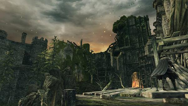 Screenshot from Dark Souls II: Scholar of the First Sin showing a character in a medieval castle with a fiery glow in the background.