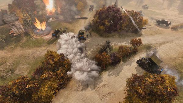 Company of Heroes 3 screenshot: Aerial view of tanks advancing through a battlefield, with explosions and smoke amid autumn trees.