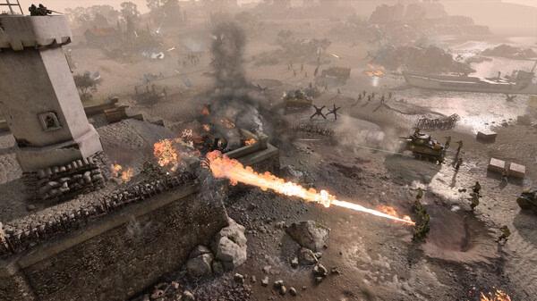 Company of Heroes 3 screenshot: Soldiers advance across a beach while tanks fire, and a flamethrower ignites a defensive position.