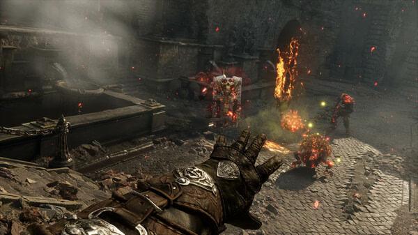 Witchfire screenshot: A gloved hand casts a spell as fiery enemies and explosions fill a desolate cobblestone courtyard.