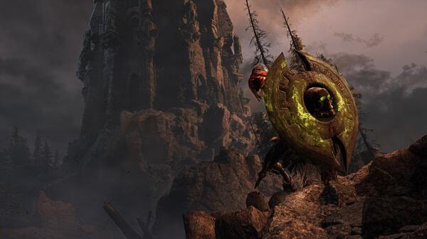 Screenshot from Witchfire: A menacing creature with a glowing shield stands in a rocky landscape beneath a towering structure.