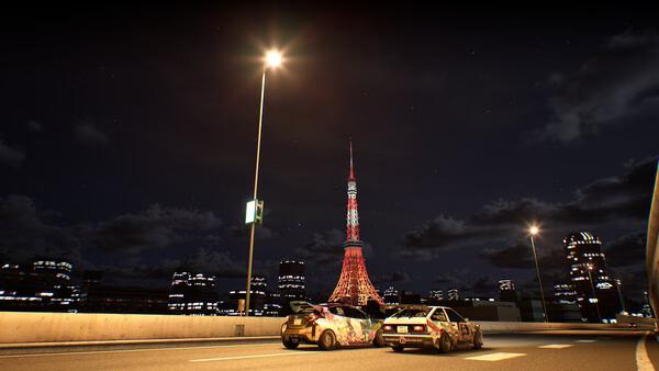 Tokyo Xtreme Racer screenshot: Two cars race under streetlights at night, with Tokyo Tower illuminated in the background.