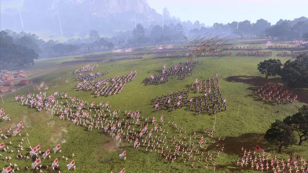 Total War: Three Kingdoms screenshot showing a large battlefield with armies clashing, banners flying, and lush greenery in the background.