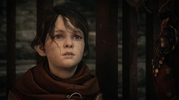 A Plague Tale: Requiem screenshot showing a young child with tousled hair, wearing a brown scarf, looking intently ahead.