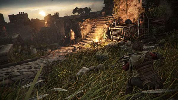 A Plague Tale: Requiem screenshot showing a character crouching in tall grass, with ruins and sunset in the background.