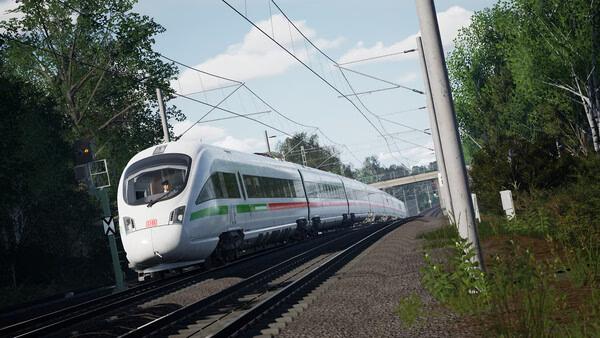 Train Sim World 6 screenshot: A sleek, modern train speeds along tracks through a lush, green landscape under a clear blue sky.