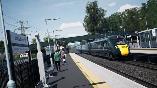 Train Sim World 6 screenshot: A modern train passes through a station, with passengers on the platform and trees in the background.