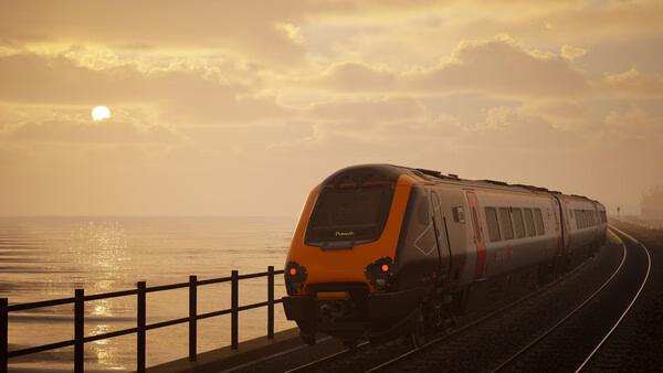 Train Sim World 6 screenshot: A modern passenger train travels along a coastal railway at sunset under a cloudy sky.