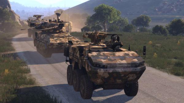 Arma 3 screenshot showing two camouflaged armored vehicles on a dirt road, surrounded by trees and hills under a clear sky.