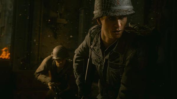 Call of Duty: WWII screenshot featuring two soldiers in helmets and combat gear, one in focus and the other partially visible in the background.