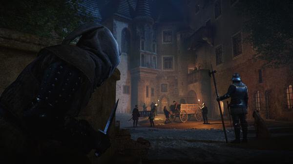 A nighttime scene in Kingdom Come: Deliverance 2 screenshot; a hooded figure hides, observing guards near a cart in a medieval town square.
