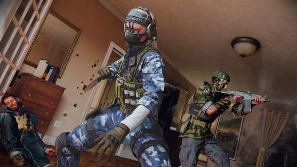 Call of Duty: Black Ops 6 screenshot showing two soldiers in combat gear aiming weapons in a room with a fallen adversary.