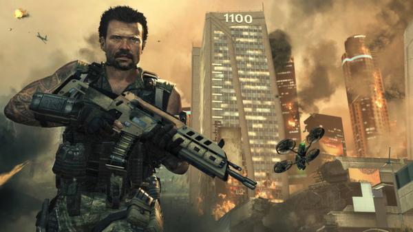 A screenshot from Call of Duty: Black Ops II shows a soldier holding a rifle with a drone flying in a war-torn city background.