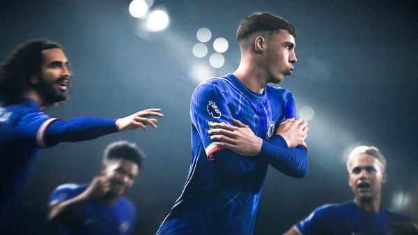 EA SPORTS FC 25 screenshot: Players on the field in blue jerseys, with one in focus crossing his arms during a match.