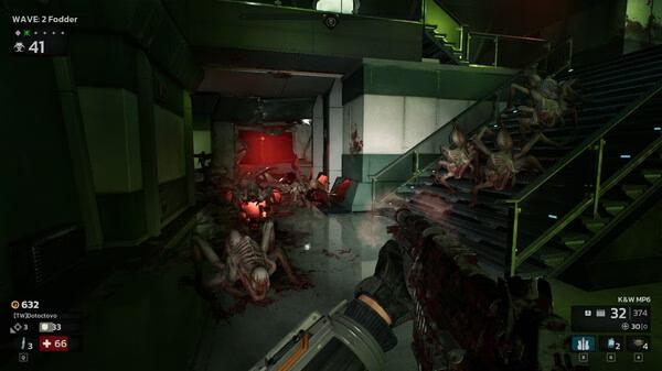 Killing Floor 3 screenshot: A player battles grotesque creatures in a dimly lit hallway with a red glow and green walls.