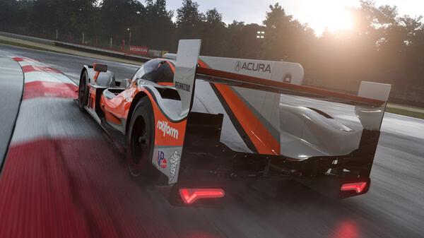 Forza Motorsport screenshot showing an Acura race car speeding on a wet track with blurred trees in the background.