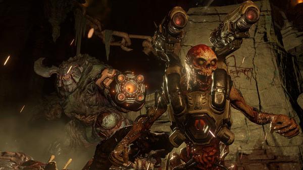DOOM screenshot: A demon with dual guns confronts a larger, monstrous creature in a dark, cavernous setting.