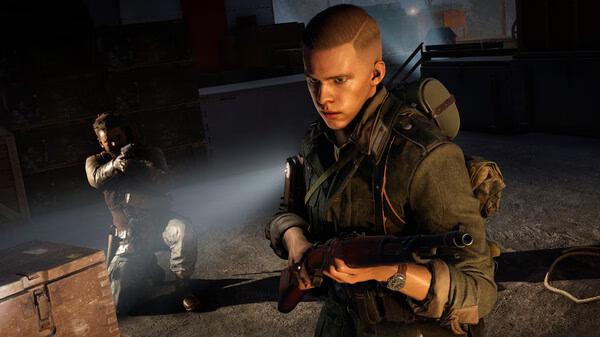 Screenshot from Sniper Elite: Resistance showing two soldiers in combat gear, one aiming a weapon, the other standing alert.