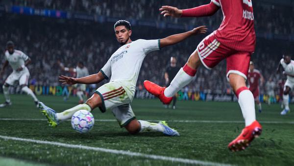 EA SPORTS FC 27 screenshot: A player in a white uniform slides to intercept the ball from an opponent in red on a grassy field.
