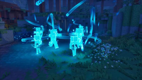 Screenshot from Minecraft Dungeons II showing glowing blue spectral figures in a grassy forest clearing at night.
