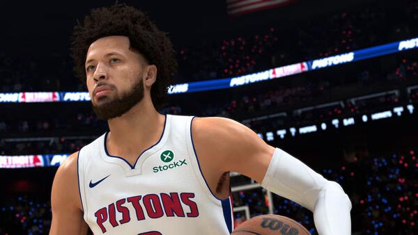 Screenshot from NBA 2K27 showing a basketball player in a Pistons jersey holding a ball on a brightly lit court.