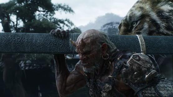 A screenshot from Black Myth: Zhong Kui showing a horned warrior carrying a large weapon, with a tiger lurking behind him.