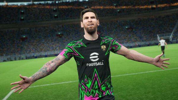 A player in a colorful jersey celebrates on the field in this eFootball™ game screenshot, with a stadium full of cheering fans.