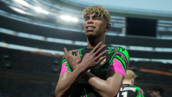 A screenshot from eFootball™ showing a football player celebrating a goal with crossed arms in a stadium.