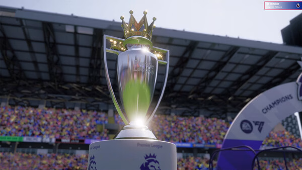 Screenshot from Football Manager 26 showing a detailed close-up of the Premier League trophy in a packed stadium.