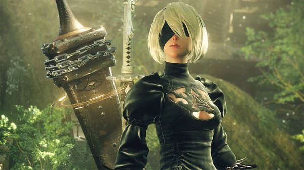 Screenshot from NieR:Automata™ showing a character in black attire standing in a lush, verdant landscape.