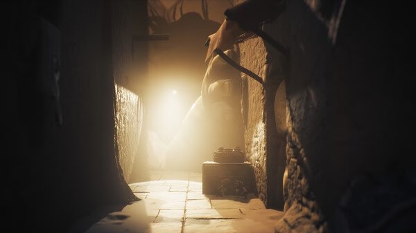A screenshot from Little Nightmares III showing a dimly lit corridor with eerie shadows and mysterious objects in the foreground.