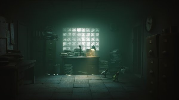 Screenshot from Little Nightmares III showing two small characters exploring a dimly lit, cluttered office with scattered papers.