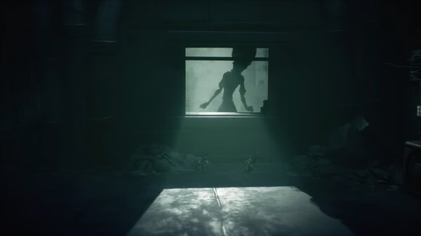 A screenshot from Little Nightmares III showing two small characters in a dark room with a shadowy figure visible through a window.