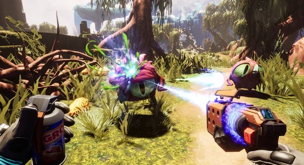 Screenshot from Journey To The Savage Planet showing a player confronting alien creatures in a vibrant, lush environment with a laser weapon.