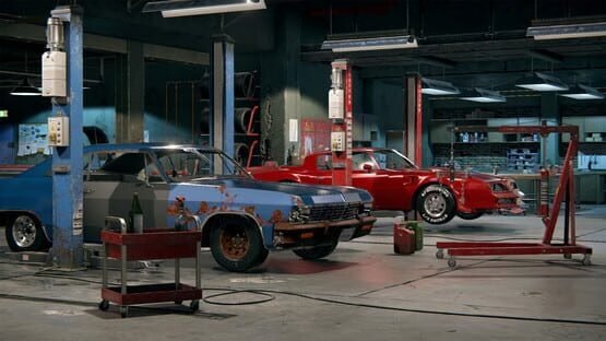 Car Mechanic Simulator 2018 screenshot: A garage with two cars, one rusty and blue, the other red, surrounded by tools and equipment.