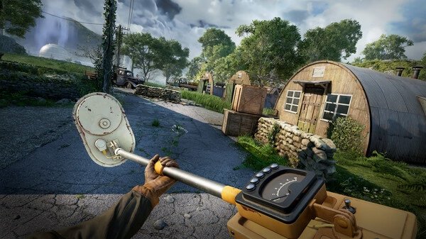 Atomfall screenshot: A player holds a metal detector in a rural area with buildings, greenery, and distant hills under a cloudy sky.