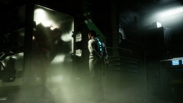 Dead Space screenshot: A lone figure stands facing a foggy glass enclosure with a shadowy creature inside, surrounded by dim lighting and machinery.