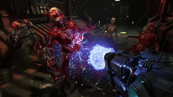 DOOM Eternal screenshot: A player wields a weapon emitting energy against grotesque, attacking demons in a dark, industrial environment.
