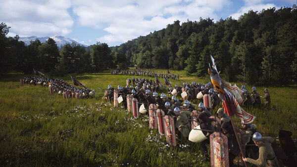 Screenshot from Manor Lords showing two medieval armies facing each other in a lush grassy field with trees and mountains in the background.
