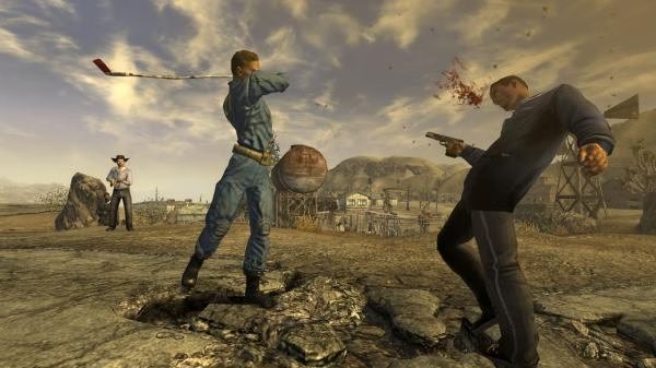 Screenshot from Fallout: New Vegas showing a Vault Dweller attacking an enemy with a golf club as blood splatters, with a desert backdrop.