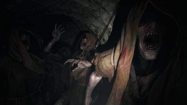 Resident Evil Village screenshot: Hooded, snarling creatures with sharp teeth emerge from a dimly lit stone tunnel, reaching out aggressively.