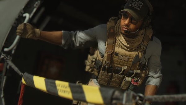 A Call of Duty®: Modern Warfare® II screenshot showing a soldier in tactical gear gripping a rope near a helicopter door.